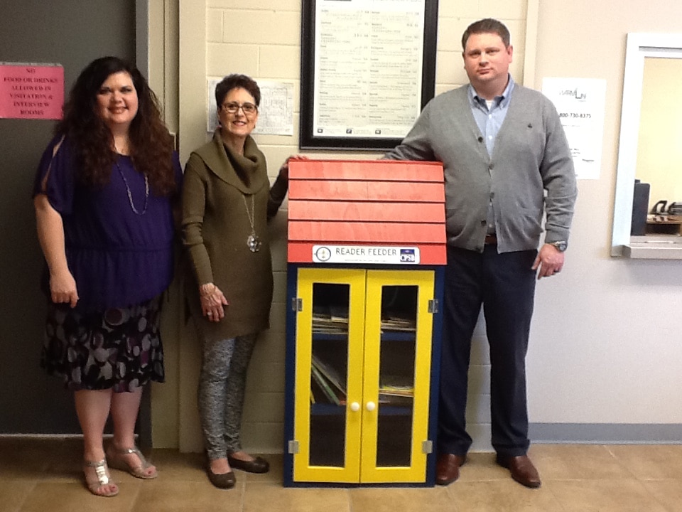 Dawn Sahualla, Area Director of Child Welfare- Dept of Children and Family Services; Jean Evans, Reader Feeder Sponsor;  and Justin Mahoney, Supervisor College St. T&I, with Reader Feeder at Dept. Of Child and Family Services. 