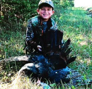 Grayson Whitehead, age 6, with his first turkey.