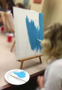 A group member paints in art session.